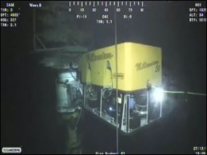 In this image taken from video provided by BP PLC, a new containment cap is lowered over the broken wellhead Monday at the site of the Deepwater Horizon oil spill in the Gulf of Mexico.