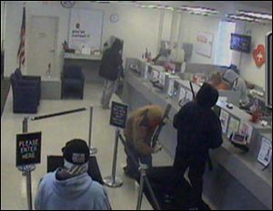 Armed men robbed KeyBank on West Central Avenue in Sylvania Township on Wednesday.