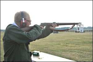 Gov. Ted Strickland fires the ceremonial first shot of Matches at Camp Perry on Monday using a historic 1878 single shot Sharps .45/70 match rifle.