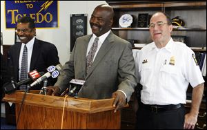 Lt. William Moton, left, Mayor Mike Bell, center, and Police Chief Mike Navarre discuss the mayor's decision reversing an order for Lieutenant Moton and Sgt. Karen Sue Martensen to retire.