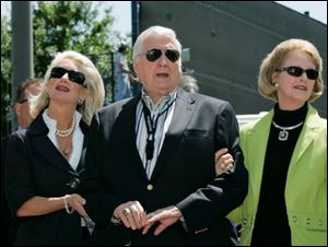 New York Yankees senior vice president for new stadium public affairs Jennifer Steinbrenner Swindal, left, holds onto her father and Yankees principal owner George Steinbrenner, center, along with his wife, Joan, during a pregame ceremony March 27, 2008, renaming Legends Field to George M. Steinbrenner Field at spring training baseball, in Tampa, Fla. 