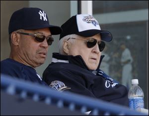 New York Yankees Hall of Famer Reggie Jackson, left, sitting with Yankees principal owner and chairman George Steinbrenner during a Yankees spring training baseball game this past March.