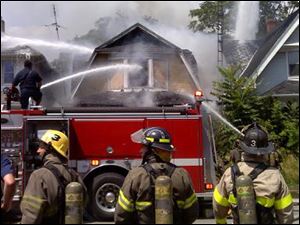 Firefighters battle a blaze at Oak and Navarre in east Toledo.