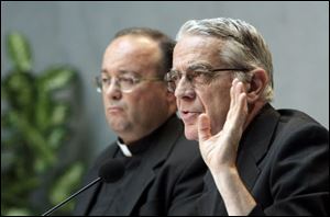 Vatican spokesman Rev. Federico Lombardi, right, and Monsignor Charles Scicluna, the Vatican's sex crimes prosecutor, talk to the media during a briefing to present a new set of norms.