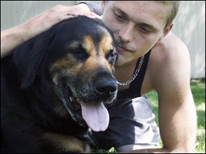 Josh Luck found his dog Tyson bleeding one day. A neighbor and his girlfriend are charged with abducting Tyson and shooting him in the chest and eye on June 23.