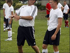 Des Davies demontrates a move as Logan Glosser of Ottawa Hills watches.
