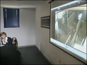 Anne Baker, executive director of the Toledo Zoo, narrates as the video of Louie the elephant attacking trainer Don RedFox during a news conference at the zoo. 