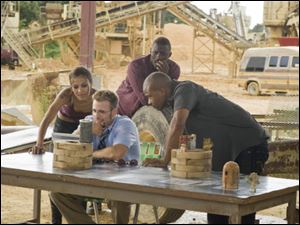 From left, Zoe Saldana as Aisha, Chris Evans as Jensen, Idris Elba as Roque and Columbus Short as Pooch  as members of 'The Losers.'