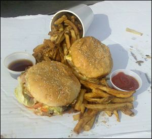 In the foreground is the regular-sized burger and behind is the little cheeseburger.