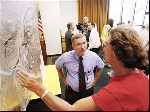 David Dysard, left, ODOT District 2 deputy director, answers a question about speed limits from David Axilrod, a Lincolnshire Woods resident, during the meeting at the Sanger Branch Library.