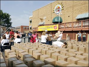 Volunteers arrange boxes of food and toiletries for distribution by Feed The Children, a national group that worked with the Salvation Army to provide extra assistance to area residents.