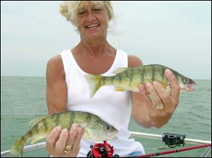 Geri Tucker displays some of her yellow perch she took from Lake Erie.