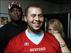 Chris Campbell talks with his parents Shron Gilbert and Tammy Campbell after coming out of a coma at Toledo Hospital.