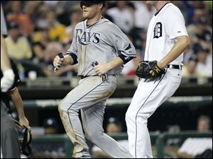 Tampa Bay's Dan Johnson scores in front of Detroit pitcher Max Scherzer after a wild pitch last night in the seventh inning.