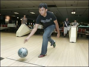 Patrapee 'Pat' Pongtana, 15, of Thailand bowls at Southwyck Lanes as he tours the local area to familiarize himself with it before school starts.