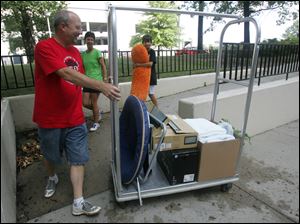 ROV moving    08/11/2010   Blade Photo/Lori King  Monroe, MI residents Scott Kish, Connie Kish and their son, McKinnon, 14, help Paxton Kish, 17, move into his Parks Tower dorm at the University of Toledo in Toledo, OH. School doesn't start at UT until Aug. 23, but Paxton is a member of the drum line and band, whose members move in earlier than most students.