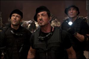 Jason Statham, from left, Sylvester Stallone and Randy Couture appear in a scene from 'The Expendables.' 