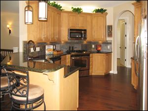 Birch cabinetry and black ubatuba granite countertops make the kitchen sylish as well as functional.