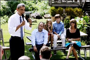 President Obama speaks about the economy while visiting Clintonville outside Columbus. He spoke to 40 people in the backyard of Joe and Rhonda Weithman, sitting with their children Josh and Rachel.
