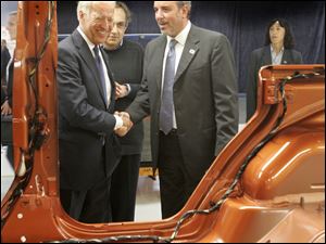 Mr. Biden shakes Jeep complex manager Mauro Pino's hand as they and Chrysler CEO Sergio Marchionne stop by a Wrangler.

