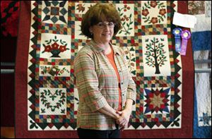 SLUG:  NBRE QUILTS19                   8/19/2010 The Blade/Amy E. Voigt        Pemberville, Ohio                                                          CAPTION:  Betty D' Emilio, from Oregon, stands infront of her 