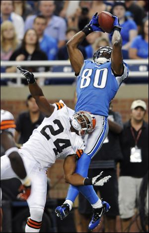 Lions wide receiver Bryant Johnson comes down with a seven-yard touchdown catch against Browns cornerback Sheldon Brown in the first quarter of Saturday's preseason game.