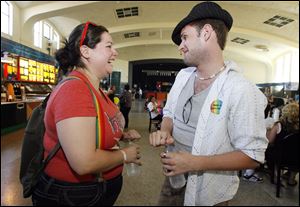 Bowling Green residents Annie Bishop, left, and Nathan Boysel stop to chat during the Toledo Pride 2010 community carnival at Erie Street Market.
