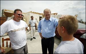 The blade
Gov. Ted Stricklandtalks with Doug Wyatt, left, and his son Devon, 11, at the site of their tornado-ravaged home in Ottawa County's Williston. Mr. Strickland visited the area twice in the days immediately after the storms in early June.