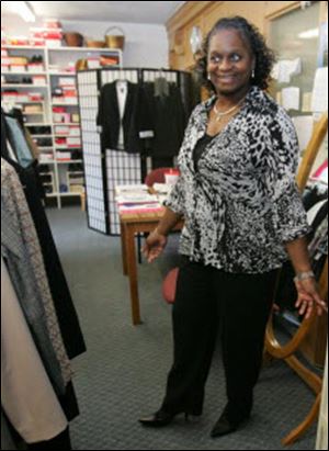 Juanita Jones models clothes that she can wear for her new job at The Source. She had been a cook and always wore uniforms.