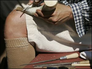 Elsewhere in the fort, re-enactor Rick Lorenzen of Traverse City but formerly of Temperance makes a powder horn. Frontiersmen kept black powder for muskets of the era in such horns.