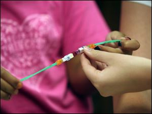 Chloe Curll, 7, of Petersburg, offers an up-close look at her creation. 