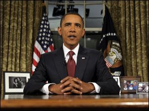 President Barack Obama reads his speech to photographers Tuesday after delivering a primetime televised address marking the the end of combat mission in Iraq from the Oval Office of the White House in Washington.