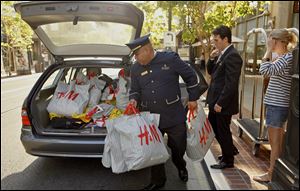 A shopper at a mall in Glendale, Calif., is confident enough to make purchases in a quantity for which she enlisted the help of a valet and a concierge in loading her car.