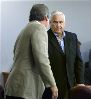 Lawyer Joseph Solomon, left, confers in court with his client Tom Cousino in the court session in which Mr. Cousino asked to enter a pretrial diversion program.
