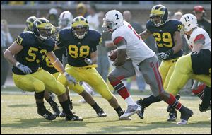 Michigan's Ryan Van Bergen (53) and Craig Roh (88), trying to chase down Ohio State's Terrelle Pryor last season, return for a defense seeking to improve upon its 82nd national ranking.