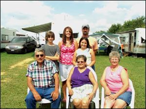 The Rice and Fredrick families of the Fayette area will be camping at the Fulton County Fairgrounds for their 32nd year. Among those in the families are, seated, from left, Richard and Nedra Fredrick and Joan Rice. Behind the the Fredricks are their daughter Kristi and her husband Kip Humbert, and two of their five children Rayce, left and Braelyn.