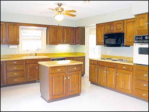 The spacious kitchen is easily the heart of the home, with miles of counter space and a convenient work island.