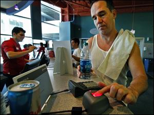 Christopher Hovde uses a fingerprint scanner for entry into a 24 Hour Fitness club in Los Angeles. The club is expected to have the scanners in all of its 428 location by year's end.