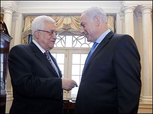 Palestinian Authority President Mahmoud Abbas, left, chats with Israeli Prime Minister Benjamin Netanyahu at the State Department in Washington.