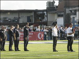 First responders take the field at the new Lake High School stadium during rededication ceremonies Friday. The tornado-ravaged remains of the former high school are shown in the background. <br>
<img src=http://www.toledoblade.com/graphics/icons/photo.gif> <font color=red><b>VIEW GALLERY:</b></font> <a href="/apps/pbcs.dll/gallery?Avis=TO&Dato=20100904&Kategori=SPORTS12&Lopenr=904009997&Ref=PH"> <b> Football: Lake Field Dedication, Northwood Game</b></a> Sept. 3, 2010
