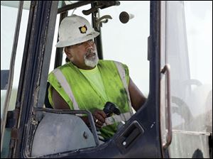 Russell Castillo, operating a backhoe at the State Rt. 24 project, says 2002 was his last year of good income, but work has picked up this season.