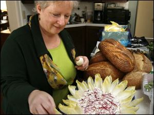 Paula Ross makes a plate of endive with dip at her Ottawa Hills home.