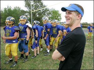Tim Berta watches practice at Ida High School, his alma mater. In 2007, he barely survived the crash of a bus carrying the Bluffton baseball team. 