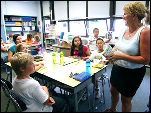 Tammy Garrison, a fifth-grade teacher at Stranahan Elementary in Sylvania Township, talks to her students about an upcoming book they will read.