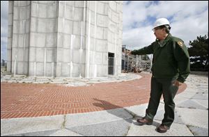 Jerry Cantu, facilities manager at Perry's Victory and International Peace Monument shows where a 500-pound piece of granite fell from the observation deck in June 2006. 