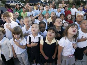 CTY remember11p  9/10/10  The Blade/Dave Zapotosky Students at Navarre Elementary School in East Toledo watch as the U.S. flag is raised in front of their school during a ceremony to remember the terrorist attacks of September 11, 2001, Friday Spetember 10, 2010.  Kindergarten students from front row left, include Karissa Santillo, Brittney Engelhardt, Justice Clark, Jewel Martinez, and Alyssa Slater.   A moment of silence was observed and essays were read by two sixth grade students, Paul Espino, and Locadio Ruiz.  Summary:  9/11 observation at Navarre Elementary School.