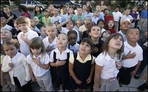 CTY remember11p  9/10/10  The Blade/Dave Zapotosky Students at Navarre Elementary School in East Toledo watch as the U.S. flag is raised in front of their school during a ceremony to remember the terrorist attacks of September 11, 2001, Friday Spetember 10, 2010.  Kindergarten students from front row left, include Karissa Santillo, Brittney Engelhardt, Justice Clark, Jewel Martinez, and Alyssa Slater.   A moment of silence was observed and essays were read by two sixth grade students, Paul Espino, and Locadio Ruiz.  Summary:  9/11 observation at Navarre Elementary School.
