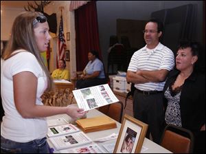 Brandi Elmore, left, of Monroe chats with Joseph Starkey, Jr., and Risa Thompson, co-chairmen of Justice for Nevaeh, at an event to promote new efforts to find the Monroe girl's killer.