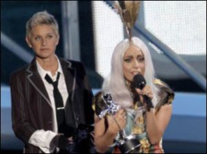 Ellen Degeneres presents Lady Gaga with one of her eight awards Sunday night.