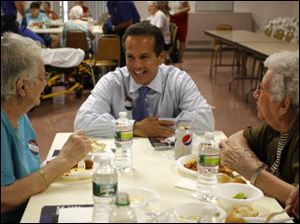 Providence, R.I. Mayor and Democratic Congressional candidate David Cicilline, center, talks with Louise Pasacane, left, and Violet Champagne, both from Woonsocket, R.I., during a pasta dinner at an elderly care facility.